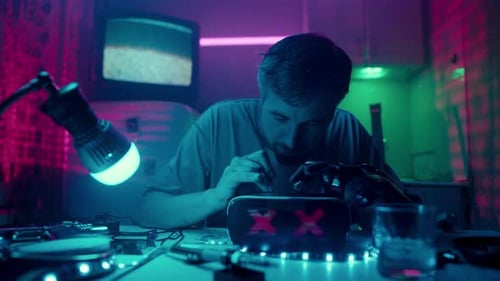 Young Adult Engineer Works with Robotics at Table