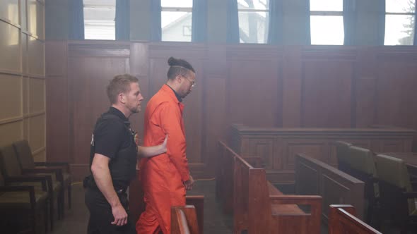 Police escorting inmate into court room trial, People Stock Footage ft ...