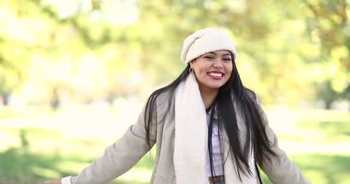Attractive girl smiling at the park on a chilly day. Shot in 4k slow motion.