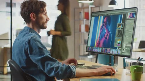 Male Digital Editor in Jeans Shirt Works in Photo Editing Software on His Personal Computer with Bi