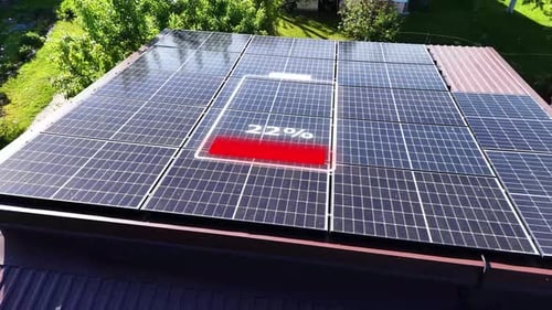Battery charge icon on top of solar panels, aerial orbit view