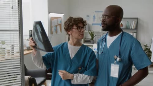 Doctors Examine X-Ray in Hospital Setting