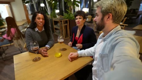 Friends Laughing While Talking in a Night Bar Terrace