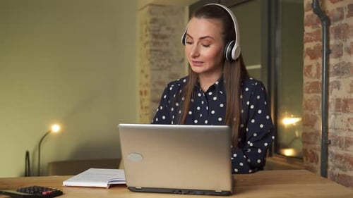 Young Woman a University Student Studies Online Using a Laptop Computer
