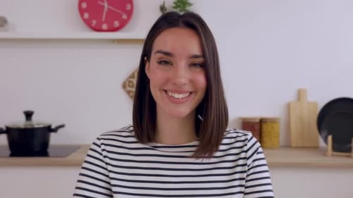 Smiling Young Adult Woman in Her Kitchen