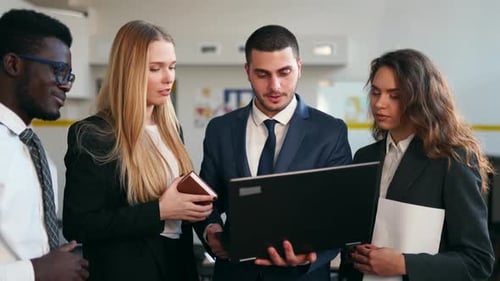 Team Working Together on Laptop in Modern Office