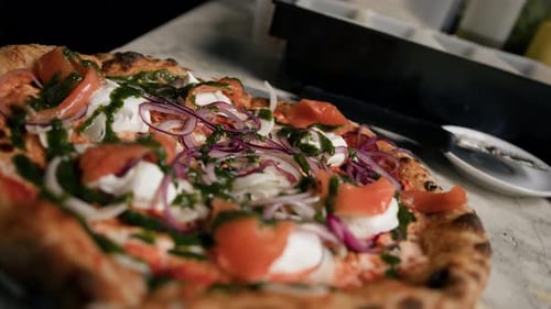 Beautiful delicious freshly cooked pizza with fish - traditional italian cuisine.