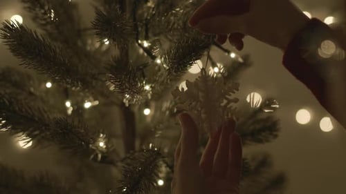 Decorating a Christmas Tree with Snowflake Ornament