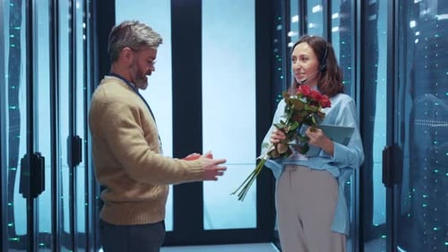 Man Giving Flowers to Woman in Server Room