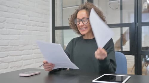 Hispanic Woman Celebrating New Contract in Office