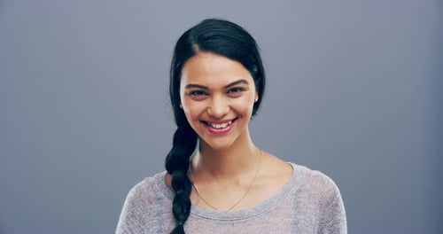 Smiling Young Woman Making Heart Shape With Hands