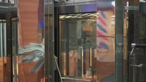Modern Glass Elevator Moving Inside Urban Shopping Mall