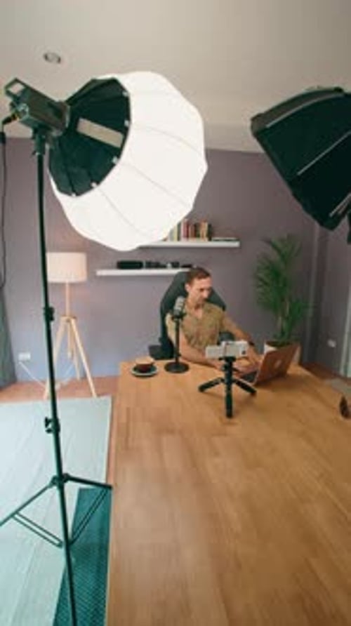 A Man is Using Professional Equipment to Record a Video Podcast in a Home Studio Setting