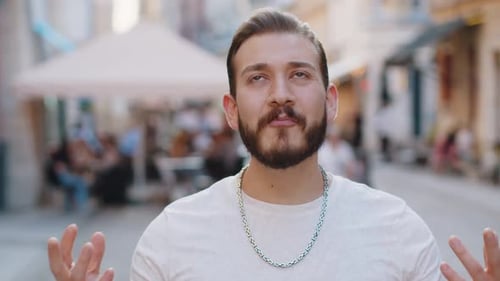Young Man Looking Surprised at Camera Shocked By Sudden Win Good Victory News Wow in City Street