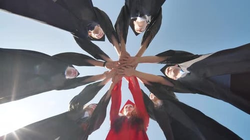 Graduates Celebrating Together, Tossing Hats into the Air