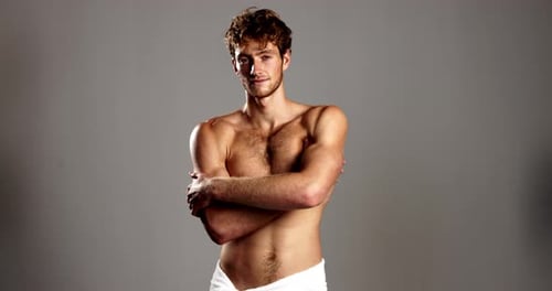 Studio, man and face with confidence for skincare, dermatology and happiness with body in towel