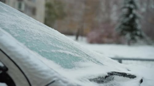 Car Covered in Fresh Snow on a Winter Day