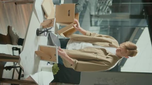 Vertical VideoYoung Upset Manager Packs His Workplace Stuff in Carton Box
