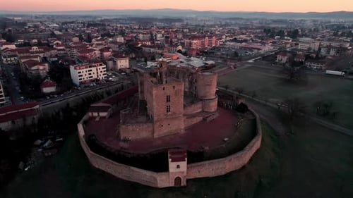 drone shot around Montrond les bains Castle at sunrise in the Plaine du Forez, Loire, french country