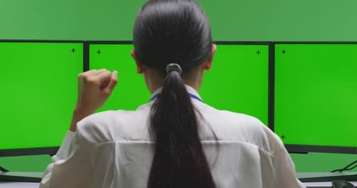 Tired Asian Woman Yawning While Working With Mock Up Multiple Monitor In Green Screen Studio