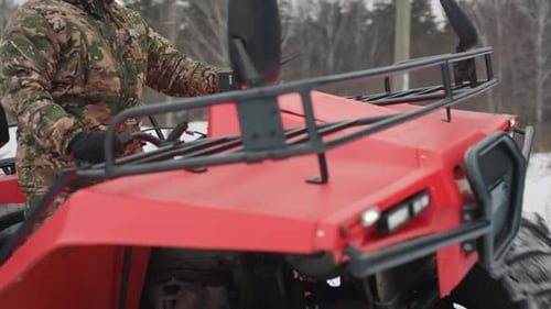 Red ATV with Snow Tires Inspected Dirt Bike in Icy Field Environment Rugged All Terrain Vehicle
