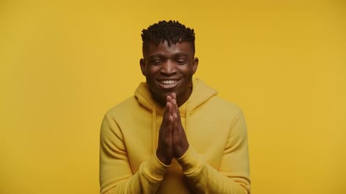 Man Smiling and Laughing in Front of Yellow Background