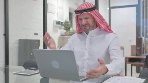 Distressed Man Working at Desk in Office