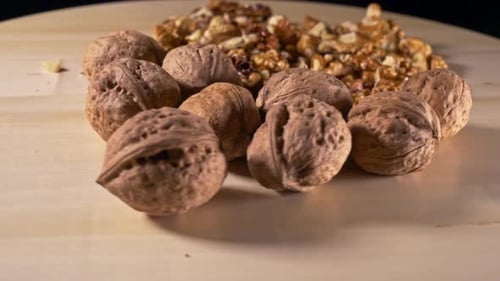 Walnuts with and without shells on wooden board