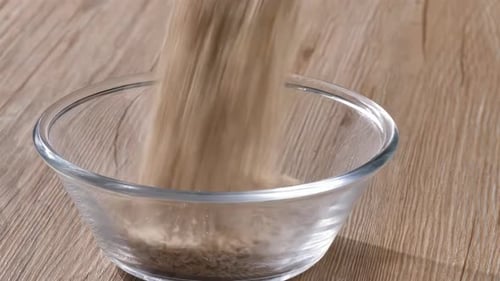 Oats Being Poured Into Glass Bowl