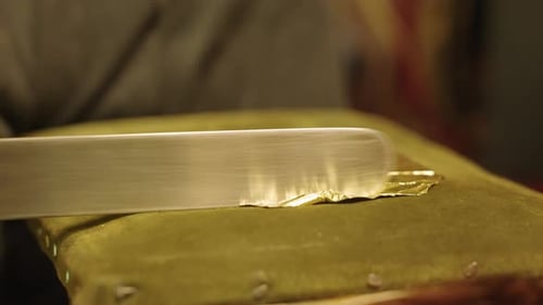 The Artist Cuts Gold Leaf Into Pieces to Apply to the Oil Painting