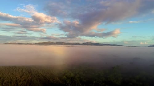Beautiful aerial view between the foggy and the mountains in the background with an impressive sky.