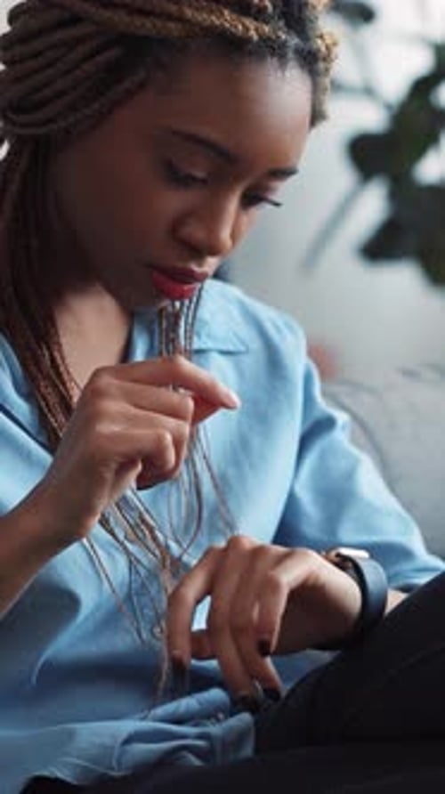 Young Woman Using Smartwatch Technology Indoors