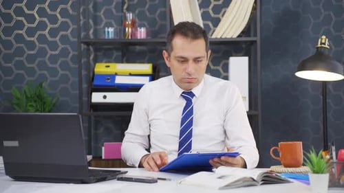 Businessman nervous and stressed at desk.