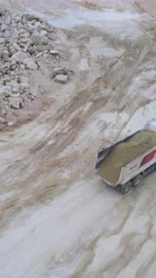 Dump Trucks Transporting Materials in Quarry Aerial Shot