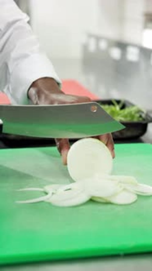 Chopping onions, cooking and hands of chef in commercial kitchen for cuisine or hospitality