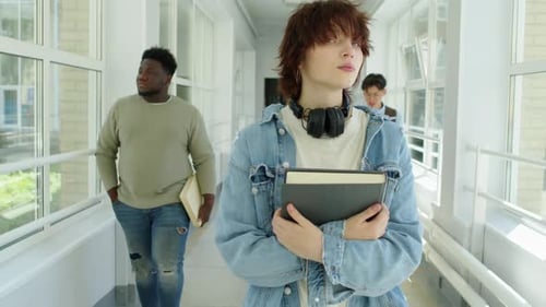 College Students Walking Along Corridor
