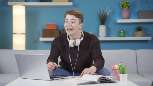 Teen Completes School Assignment on Laptop