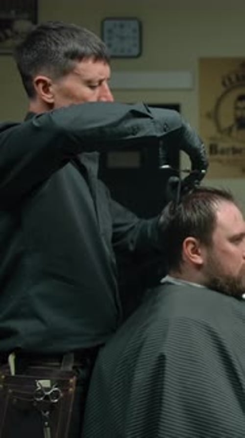 Barber Giving Haircut in Barbershop