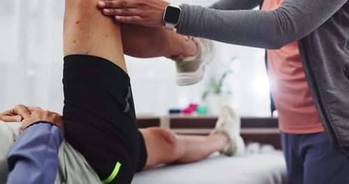 Medical Professional Giving Knee Massage on Table