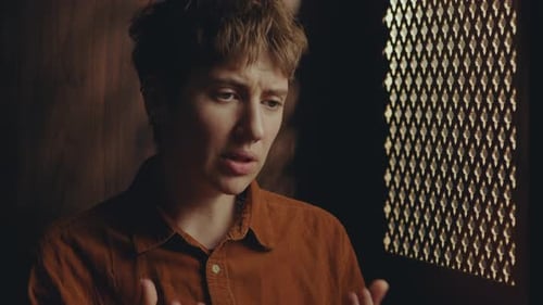 Young Female Penitent Talking in Confessional Stall