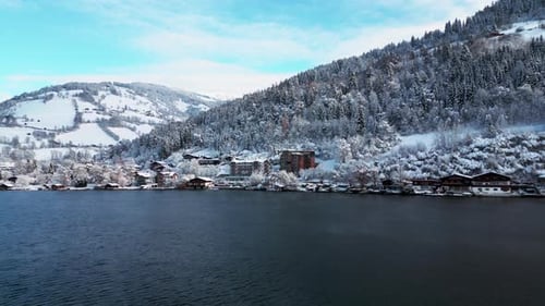 Drone Approaching Snowy Lakeside Village