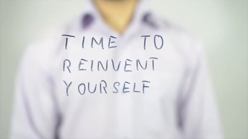 Man Writes Time to Reinvent Yourself with Marker