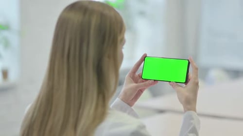 Woman Holding Smartphone with Green Screen