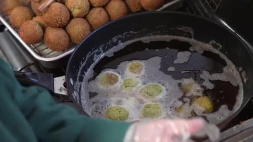 Chef Frying Falafel in Restaurant Kitchen