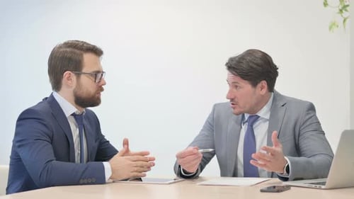 Businessmen Discussing Document in Office Meeting