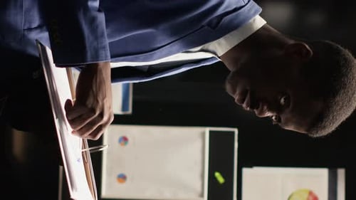 Vertical Video Investigator Examines Evidence in Office