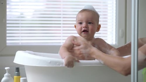 Smiling Infant Enjoying Bath Time