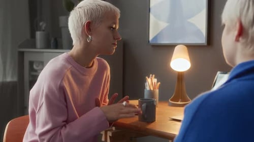 Female Colleagues with Hard of Hearing Using Laptop at Home Office