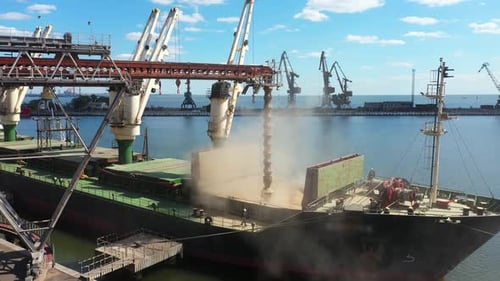 Aerial of Wheat Loading to Bulker Ship Cargo Hold at Sea Grain Elevator in Sea Port Wheat Shipment