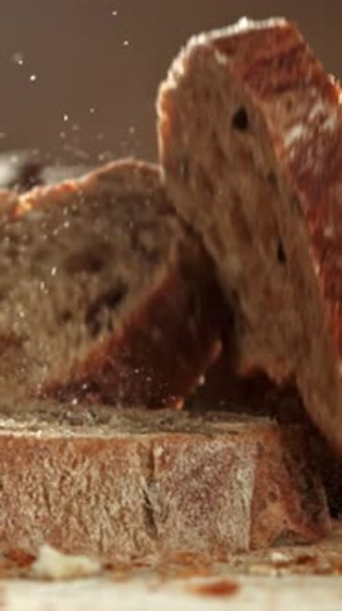 Pieces of Sliced Baguette Fall on the Table Filmed on a Highspeed Camera at 1000 Fps